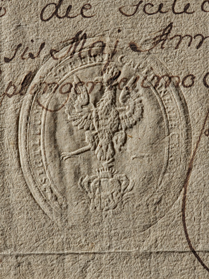 Starost's Office of Kraków, Starost's Office (ca. 1776), coat of arms seals, Zurakowski, Witold (?-1927), private seals, starosts' seals, document seals, Starykon (coat of arms), Oval seal of the Starost's Office of Kraków. Crowned eagle, below a crowned shield with the Starykon coat of arms. Illegible inscription on the rim. 1776, Kraków, Poland, seal, dimensions 1: 49 mm; dimensions 2: 58.5 mm, The image shows a close-up of a textured, beige paper with an embossed oval seal featuring a raised double-headed eagle and ornamental elements; a few areas of brown ink handwriting overlap the seal and paper, forming curved strokes and loops.