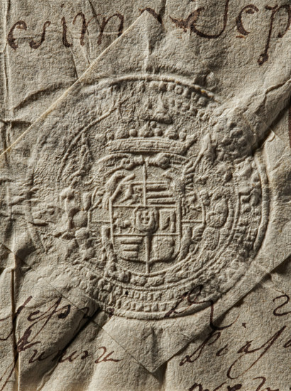 Seal of Karol Wielopolski, starost of Kraków (?-1773). Round seal impression. Multi-field shield under a crown supported by four eagles; in the heart-shaped field the Jastrzebiec coat of arms. Fields: 1—Gryf; 2 and 5—Korczak; 3—Starykon; 4—Axe; 6—unknown. Behind the shield a panoply. Double rim with illegible inscription. 1767, Poland., A close-up of a textured, wrinkled paper surface in beige and tan tones with a raised circular embossed seal at the center showing ornate patterns and heraldic shapes, surrounded by creases and fold lines; a few areas show dark brown ink strokes partially visible along the paper edges, and subtle shadows emphasize the crumpled texture and depth of the embossing.