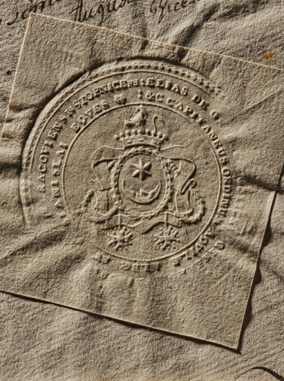 Seal of Eliasz Wodzicki, Starost of Kraków. Round seal impression of Eliasz Wodzicki, Starost of Kraków. In an oval cartouche with a rim of oak leaves is the Leliwa coat of arms; on the sashes are the Order of the White Eagle and St. Stanislaus. In the double rim is a largely illegible inscription: ELIAS DE GR, CRACOVIENSIS STOPNICENS//&C CAPITANEUS ORDINUM AQVILAE, STANISLAI EQVES, 1789. Poland., A close-up view of textured, crumpled paper in beige and tan tones with a raised circular embossed seal featuring a decorative crest; the crest includes a crown, a shield with a star and crescent-like shape, ornate ribbons and floral-like motifs, all pressed into the paper creating shadows and highlights; overlapping sheets create visible edges and layered corners, with subtle darker brown spots and slight creases and folds across the surface.