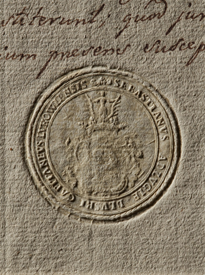 Seal of Sebastian Dluski, starost of Luków. Round seal impression. On the decorative shield, the Nalecz coat of arms with a jewel above the rank crown. In the rim, the inscription: SEBASTIANUS ADLVGIE DLVSKI CAPITANEVS LVKOWIENSIS, 1778, Poland., A close-up of textured paper in beige and light brown tones showing an embossed circular seal with raised and recessed details, surrounded by a faint circular border and ornate crest-like patterns; above the seal there is cursive handwriting in dark brown ink, and the paper shows a fibrous, slightly rough surface with subtle shadows and highlights.