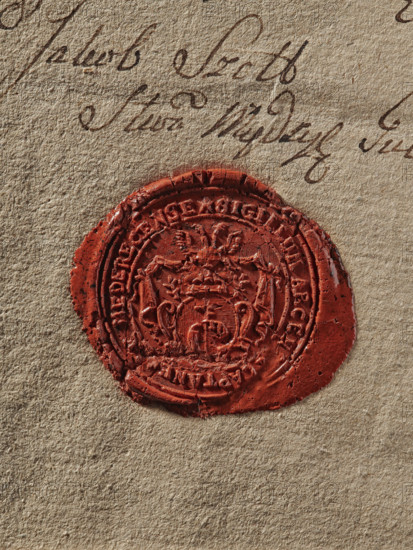 Seal of the starosty seat of Miedzyrzecz, starosta of Miedzyrzecz (ca. 1788). Round wax impression of the seal of the starosty seat of Miedzyrzecz. Shield with the coat of arms of Prus III Nagoda placed on the mantle. In the rim there is an inscription: SIGILLUM ARCEN, CAPTANEUS MEDERECENSE. 1788. Poland. Seal., A close-up of textured beige paper showing a circular red wax seal pressed into the surface with an ornate raised design and rough cracked edges, and a few sweeping dark brown ink pen strokes above the seal; colors visible include beige, red, and dark brown.