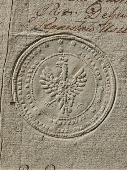 Seal of the Civil-Military Order Commission of the Kraków Voivodeship, Lelów County and the Duchy of Kraków; Round seal featuring a crowned Polish eagle; rim inscription: 'SEAL OF THE CIVIL-MILIARY COMMISSION OF THE KRAKOW VOIVODESHIP // THE DISTRICT OF THE XIESKIE AND LELOW COUNTIES, 1790'; seal, Poland., A close-up of an embossed circular seal pressed into textured beige paper showing a raised heraldic eagle with outstretched wings at the center, surrounded by concentric decorative ridges and a beaded border, with a few small dark brown marks and smudges on the paper and a section of cursive handwriting in brown ink visible near the top edge.