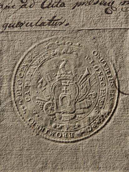 Seal of Onufry Bromirski from Bromierz, starost of Plock, Onufry Bromirski (1740–1834). Round seal impression. In a decorative cartouche, the Pobóg coat of arms with a jewel above the rank crown. Rich labres around the cartouche. In a double rim, a partially illegible inscription: ONUFRIUS IN, ERPC, BROMIRSKI PLOCENSIS // PLONSCENSIS CAPITANEUS, 1786, Poland, seal, coat of arms seals, document seal, starost's private seal., The image shows a close-up of a textured, beige paper surface with an embossed circular seal featuring an ornate central crest and surrounding decorative elements; a portion of handwritten ink appears near the top edge. Colors visible include beige, tan, brown, and dark brown.