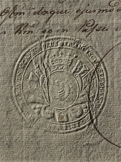 Seal of Franciszek Stefan Lanckoronski of Brzezie, Starost of Rawa Mazowiecka, Franciszek Stefan Lanckoronski (1754–1789); round seal impression, Zadora coat of arms; illegible impression, 1779, Poland; document/private/starost's seal., The image shows a close-up of textured beige paper with an embossed circular seal featuring a crowned crest and decorative elements; there is dark brown ink handwriting partially visible near the top and crossing over the seal, and a curved dark brown line extending from the right side. The visible colors are beige, various shades of brown, and a hint of gray in the paper texture.