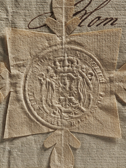 Round seal impression of the Prussian Admiralty in Königsberg. Decorative crowned coat of arms: a crowned eagle with a crown around its neck and on its chest a shield with an illegible drawing. In the rim the inscription: KONIGLICH PREUS. SCH ADMIRALITA. SIEGEL. 1766. Prussia, Königsberg. Official Admiralty document seal., A close-up of textured beige paper with an embossed circular seal framed by a decorative cross-shaped cutout, showing raised and recessed details of the seal and layered paper edges; the visible colors are shades of beige and brown with darker brown ink strokes partially visible behind the paper cutout.