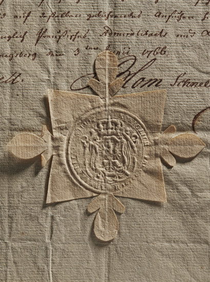 Prussian Admiralty seal, Admiralty, official seals, document seals, seals with coat of arms. Round seal impression of the Prussian Admiralty in Königsberg. Decorative crowned coat of arms: a crowned eagle with a crown around its neck, and on its chest a shield with an illegible drawing. In the rim is the inscription: KONIGLICH PREUS, SCH ADMIRALITA, SIEGEL, 1766. Prussia, Königsberg, seal., A close-up of textured paper in beige and tan tones with a raised, ornate embossed seal in the center made of slightly darker paper; the seal is mounted on a cross-shaped backing with petal-like cutouts extending outward, and faint brown cursive ink marks are visible behind and around the seal.