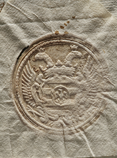 Two seal impressions on a document. Two seal impressions with a double-headed crowned eagle and a coat of arms in the center. Dry seal impression; a clergyman stands in front, holding a crosier in his right hand. Official archbishop's curia seal on documents; church and archbishop's seals with religious symbols. 1770, Genoa, Italy., A textured off-white sheet with a circular embossed design featuring a decorative crest; the embossing shows a raised wreath-like border, ornate curved shapes and shield elements, and wing-like feathered patterns. The surface has subtle wrinkles and creases, a few small brownish stains above the circle, and some darker brown aging within the embossed lines. Visible colors include off-white, beige, light tan, and brown.