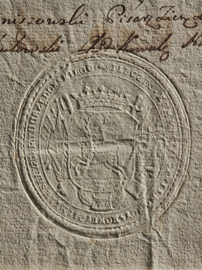 Round dry impression of the seal of the Civil-Military Order Commission of the Lublin Province, 1790. Official seal attached to documents; round impression showing a crowned coat of arms with a deer wearing a crown around its neck running to the right, a panoply behind the shield, and a rim inscription: 'SEAL OF THE CIVILIAN-MILIARY COMMITTEE OF THE LUBELSKA COUNTY'. Poland — Urzedów poviat, Lublin region., An embossed circular seal pressed into textured beige paper with an ornate coat of arms at its center showing a crowned shield flanked by decorative elements and a figure holding a staff, with handwriting in dark brown ink visible near the top edge; colors include beige, tan, off-white, and dark brown.