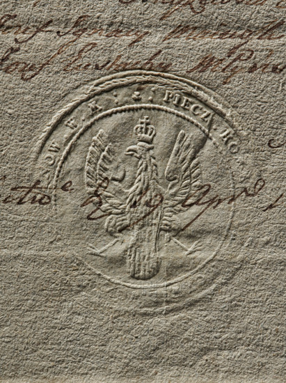Seal of the Civil-Military Order Commission of the Duchy of Mazovia and Ciechanów Land. Dry impression, document seal; round impression. Coat of arms of the Duchy of Mazovia — a crowned eagle with its head turned right. Around the rim: inscription 'PIECZ. KOM. NOW. W. M., 1790'. Duchy of Masovia (1138–1526); Ciechanów Land; Poland., A close-up of textured paper in beige and tan tones showing an embossed circular seal with a raised two-headed eagle wearing a crown and detailed feathered wings, surrounded by a circular rope-like border and outer ring; over the seal and paper there is a cursive script in dark brown ink that crosses the image, and the paper surface shows creases, fibers, and uneven grain in shades of light brown, cream, and gray.