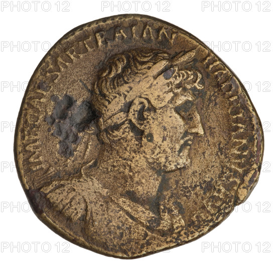Sestertius of Hadrian (76–138; Roman emperor 117–138). Obverse: bust of Hadrian facing right wearing a laurel wreath; rim inscription IMPCAESARTRAIANHADRIANVSAVG. Reverse: Minerva standing left, in a long robe and helmet; in her right hand she holds an incense/gift which she throws onto a candelabrum opposite her, in her left hand she holds a vertically held spear; a shield rests against her leg with a snake crawling on it; control letters SC at sides; inscription at bottom PM TR P COS III. Date: 121–122. Rome, Roman Empire (27 BC–476). Coin; weight 25.67 g.