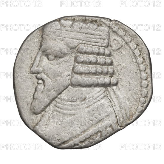 Tetradrachm of Gotarzes II (Parthian king, reign c. 40–51 CE). Obverse: bust of Gotarzes II facing left, with long beard, curled hair, wearing a diadem, necklace, and cuirass. Reverse: Gotarzes II facing right, seated on a throne; Tyche (personification) standing before him, offering a diadem in her right hand and holding a cornucopia in her left. Parthia (Iran), dated 38–51 CE. Coin; diameter 26.0–27.0 mm; weight 13.50 g.