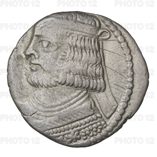 Tetradrachm of Vardanes II (55–58 CE). Obverse: bust of Vardanes II wearing a diadem, facing left. Reverse: Vardanes II seated on a throne, facing left; Tyche (personification) with a wreath in front of him. Parthian Kingdom, Iran. Coin; diameter 28.0 × 29.5 mm, weight 12.57 g.