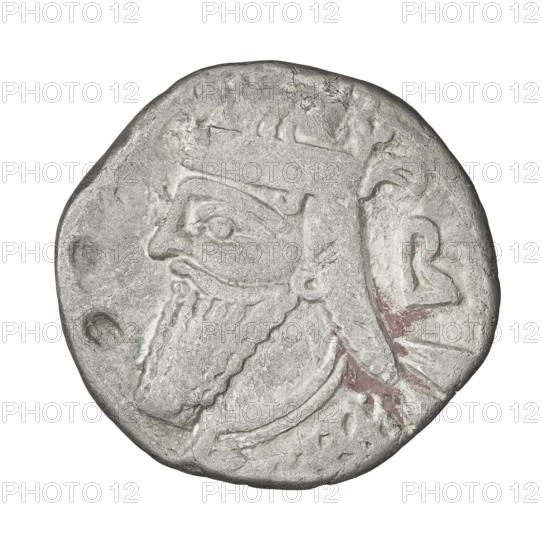 Tetradrachm (subaerate?), Vologases IV (king of the Parthians; 147–191). Obverse: head of Vologases IV wearing a diadem, facing left; control mark B at right. Reverse: Vologases IV seated on a throne, facing left; before him the goddess Tyche standing, facing right, holding a wreath and a scepter in her right hand. Parthian Kingdom, Seleucia on the Tigris, Iran. Circa 147–191. Coin; diameter 25.5–26.0 mm; weight 7.20 g.