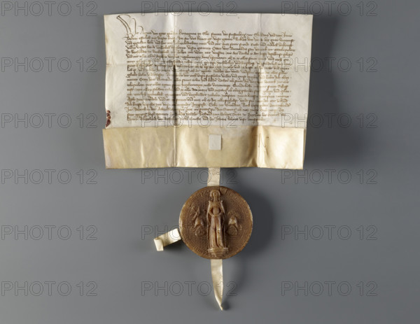 Majestic wax seal attached to a document belonging to Agnieszka (Duchess of Swidnica; reign 1368–1392). Princely/rulers' seal, dated 1389. In the field of the seal the duchess stands in a long robe and a long cloak fastened with a button, wearing a headdress. On the sides are two shields: Swidnica and Silesia, topped with jeweled helmets in a heraldic arrangement. Next to the duchess's head a shield with the Austrian coat of arms is woven into the rim inscription. The background is diagonally checkered. Around the rim, an inscription in minuscule: AGNES . DEI . GRA . DUCISSA . SLE . DNA . DE . FURSTENB'G . IN . SWYDNICZ ET . IN . HYAVOR. Seal diameter: 90 mm. Document dimensions: 193 mm and 260 + 52 mm.