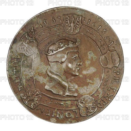 Crown medal thaler, Sigismund I the Old (King of Poland; 1506–1548). Obverse: bust of Sigismund I in a coif and crown. In the rim, five shields with the coats of arms of Poland, Lithuania, Royal Prussia, Red Ruthenia, and Austria; inscription separated by coats of arms: SIGISM P REX PO LONIE MD LITHV 1533. Reverse: bust of Sigismund Augustus in a coif and crown. In the rim, shields with the coats of arms of Poland, Lithuania, Royal Prussia, Red Ruthenia, and Bona Sforza; inscription divided by shields: SIG : AVG : SECVND FILIVS : REX PO LON sc. Dated 1533. Coin (thaler), weight 26.57 g, Torun, Poland., A circular metal coin with a worn, mottled surface showing shades of brown, green, and pale gray, featuring a raised profile of a person wearing a crown facing right at the center, surrounded by a decorative border with several small shield-like shapes and ornamental elements; the coin shows areas of patina and surface erosion, with lighter and darker patches across the relief and rim.