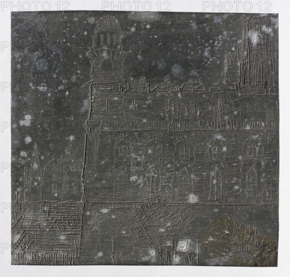 Fragment of the city; Jablczynski, Feliks (1865–1928); graphic artist; cityscapes; towers; cities; stairs; city views; architectural studies; trees; tenement houses; Polish graphic art; Poland; ca. 1924; Warsaw; graphic art; graphic matrix (graphic plate); height 8 cm; width 8.4 cm, The image shows a textured dark gray rectangular surface with etched lines forming architectural shapes such as a tower, arches, rooftops, and building outlines, with lighter gray speckles scattered across the surface; a narrow white border frames the dark rectangle, and there are hints of brown and muted green in the lower right area near what appear as etched plant-like lines.