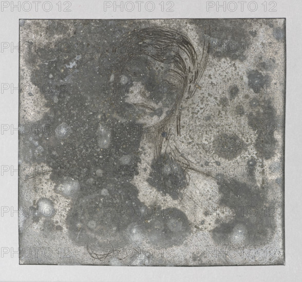 Sketch of a woman's head; Jablczynski, Feliks (1865–1928), graphic artist; studies of women's heads; head studies; women; Polish graphics; Poland; ca. 1924; graphics; graphic matrix/graphic plate; height 6.7 cm, width 7.4 cm, A square metallic plate with a textured, mottled surface showing a mix of gray, dark gray, silver, and off-white tones, with a faint scratched outline of a human face and hair near the upper center. The face outline is formed by thin, curved etched lines suggesting hair strands and facial contours, and there are a few scattered darker smudges and lighter circular spots across the plate. The plate sits on a light gray background border and shows subtle scratches, speckles, and variations in sheen across its surface.