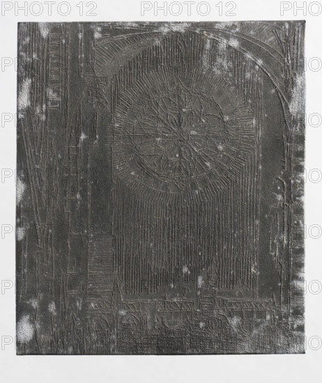 Gothic interior with a rosette; Feliks Jablczynski (1865–1928), graphic artist; church interior architectural study featuring a rosette and stained glass window; studies of architectural details; Gothic style; ca. 1924; Poland; graphic art; graphic matrix/plate; height 8.4 cm, width 7.3 cm, A rectangular dark textured panel with a rough surface showing carved linear patterns and a large circular rosette-like motif near the upper center, surrounded by radiating grooves and vertical striations; a high arch shape frames the central area with carved vertical lines filling the space beneath the rosette, and the lower portion shows a band of carved geometric and arch-like shapes. The panel has scattered lighter scuff marks and dusting across its surface, and it rests against a lighter neutral background. The visible colors are dark gray to black for the panel and light gray to white for the background and scuffed areas.