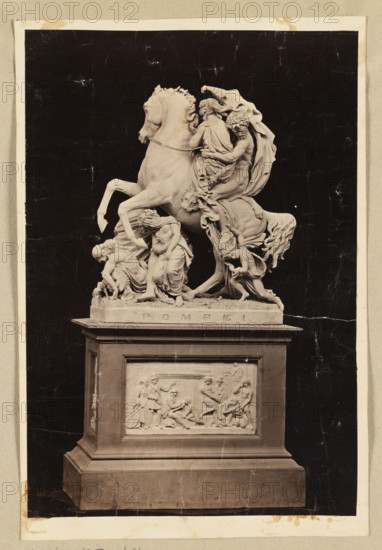 Photograph of Wiktor Brodzki's sculpture 'Escape from Pompeii' (Pompeii Fugue). View showing the sculpture on its pedestal from the side with the inscription 'POMPEI'. Photographer/publisher: Suscipj, Lorenzo (Rome; photographic studio; 183?-1901). Sculptor: Wiktor Brodzki Polearch (1817/1826?–1904). Subjects: escapes, horses, children, women, men. Boczkowska, Maria Celestyna (1840–1931) noted in connection. Date: ca. 1868, Rome. Medium: photographic print/photograph. Dimensions: height 29.5 cm, width 14.8 cm.