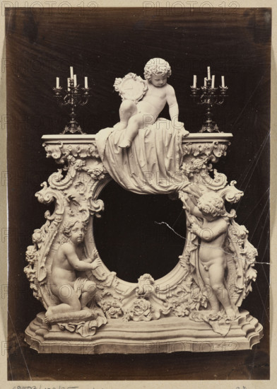 Photograph of a sculpture by Wiktor Brodzki showing a neo-rococo fireplace frame with three putti; sculptor Wiktor Brodzki (c. 1826–1904); subject: putti, children's nudes, fireplace decoration, clocks, candlesticks, designs for architectural decorations; style: neo-rococo; medium: photograph (photographic print); date: ca. 1868; place: Rome; dimensions: height 24.1 cm, width 17.2 cm.