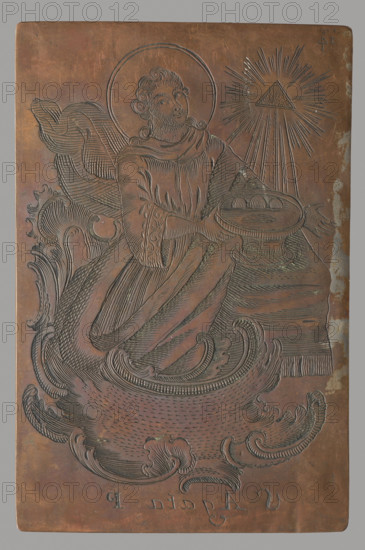 Saint Agata, Jan Masieski (Maszewski) (fl. ca. 1750–1800), graphic artist; depiction: figure of a kneeling saint at the bottom, frame–pedestal in rocaille ornament, top right the symbol of the Holy Trinity (triangle with rays). The author is probably Jan Maszewski (Masieski). Signature under the image of Saint Casimir: IMVS (Ian Masieski Vilnesis Sculpsit). Masieski also used monograms (e.g., IM V. sc., IMS, IM). Possibly active in Vilnius. 2nd half of the 18th century. Graphic plate (matrix). Dimensions: height 10.3 cm; width 6.7 cm; thickness 0.1 cm.