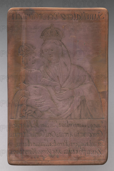 Recto: Our Lady of the Sand (Sum Mater & Decor Carmeli); verso: Fragment of a composition with the inscription 'ARIES'. Mary (mother of Jesus Christ). Image of the Virgin Mary with Baby Jesus in closed crowns, in bust, enclosed in a linear frame with areas for inscriptions at the top and bottom. Depicts Our Lady of Piasek, located in the Kraków church of the Carmelite Fathers on Piasek, dedicated to the Visitation of the Blessed Virgin Mary. Legend: a Carmelite painter (ca. 1500) began the image on the external wall above a side door, left when the prayer bell rang, and an invisible hand completed it. Stanislaw Tomkowicz dated the painting to the Renaissance; currently dated to the fourth quarter of the 15th century or around 1500. The Carmelite artist remains anonymous. Ca. 1800. Print, graphic matrix/plate. Height 12.6 cm, width 8 cm.