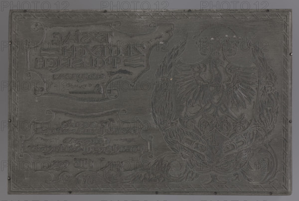 1000 Polish zloty voucher for Polish military purposes; graphic artist; Polish Military Treasury; Polish vouchers; military vouchers; White Eagle (coat of arms, Poland); panoply; Uhlan shako (iconographic); oak half-wreaths; laurel half-wreaths; 1916; graphic matrix; height 11.8 cm; width 18.2 cm; thickness 2.3 cm; graphic matrix: height 11.8 cm; width 18.2 cm; thickness 0.2 cm