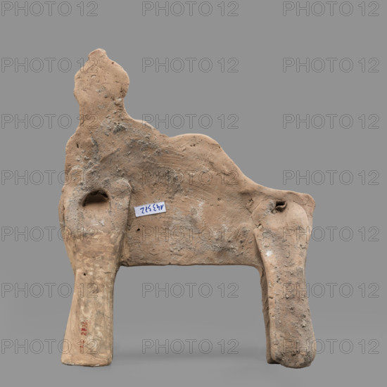 Figurine of a feasting Dionysus, author Scen.Gal.Klass. Figurine of a feasting man resting on a bed in a semi-reclining position, leaning on his left elbow and holding a cup in that hand. The torso is naked and the lower part of the figure is covered from the waist with a cloak, the end of which is thrown over the left forearm onto a pillow. On the head is a diadem decorated with pearls, an astral rosette above which a lotus flower protrudes. Red clay, medium-grained with tiny mica particles. 5th century BC (dating before a 2019 revision: late 6th century BC; analogous artifact dated to 480–470 BC). Tarentum. Figurine. Height 19 cm, width 15.2 cm, depth 3.3 cm, weight 0.34 kg.