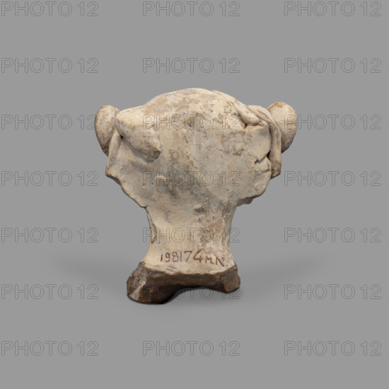 Head of a figurine of Dionysus. Head of a young man with a face devoid of expression, with a wide, compact mouth, a triangularly outlined face with carved cheeks, large eyes, a prominent nose and gently outlined eyebrows. The youth wears a diadem decorated with rosettes on the sides and a thick wreath. Traces of red paint (cinnabar) on the hair, lips and diadem; blue on the rosettes (in the recesses). 5th–4th century BC, Taranto, Southern Italy, figurine. Height 8.7 cm; width 8.3 cm; depth 6.3 cm; weight 0.28 kg.