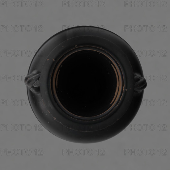 Black-finished amphora, engobe; surface finished with a glossy black engobe. Amphora with a disc-shaped base. Pear-shaped belly with clearly defined shoulders. Short neck separated from the shoulders by a ring. Wide, outward-curving rim. Two twisted handles (S2 twist), attached vertically between the neck and the shoulders. No engobe on the base. Preservation condition: slight losses in the lower part of the belly and on the rim. 5th century BC, Attica. Vessel (amphora). Height 21 cm, width 12 cm.