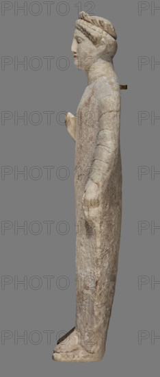 Votive figure of a youth holding a bird, Cypriot votive sculpture. Figurine of a youth shown standing, left arm down at his side holding a 'handkerchief', right arm bent at the elbow and raised upwards with palm open facing forward. Dressed in a chiton and himation; folds of the chiton marked with slightly wavy shallow lines, folds of the himation highlighted with an engraved schematic line. Relatively small head with regular features, visible eyes, straight nose, and traces of red polychrome on the lips. Hairstyle of small curled locks arranged in two rows; hair decorated with a diadem with traces of red polychrome. Back of the sculpture unfinished. Dated 480–310 BC (previous attribution: first half of the 5th century BC). Cyprus, terracotta sculpture, height 43 cm, width 14 cm, depth 14 cm, weight 3.03 kg.