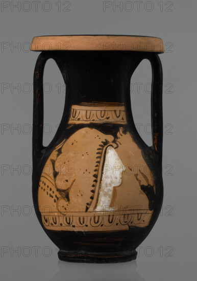 Red-figure pelike, Attic workshop, pelike (vessel), antique vessel, pink clay. Slightly matte black engobe. Some elements painted white. Pelike with a slender belly. Wide neck, widening upwards. Rim rolled outward and decorated with a frieze (ox-eyes). Two bipartite handles attached vertically below the rim, extending to the gently sloping shoulders. On either side of the body, two scenes are bounded at the top and bottom by an ox-eyes frieze. Kerch style. Scene A: Woman's head turned to the right, wearing a Phrygian cap; edge of the cap marked with a black line with elongated points. Face and neck painted white. In the background on the right, a horse protoma; on the left, the front part of a griffin. Scene B: Two male figures facing each other, wrapped in long cloaks; facial features unmarked. Preservation status: partially reconstructed rim. 2nd half of the 4th century BC, Attica. Vessel: pelike. Height 29.9 cm, width 13.1 cm.