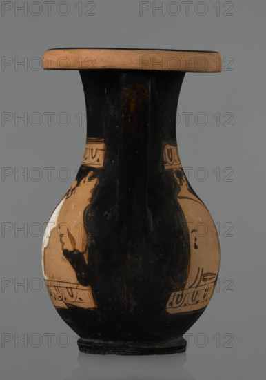 Red-figure pelike, Attic workshop. Pelike (vessel) of pink clay with slightly matte black engobe; some elements painted white. Slender-bellied pelike with wide neck widening upwards; rim rolled outward and decorated with a frieze of ox-eyes. Two bipartite handles attached vertically below the rim, extending to gently sloping shoulders. Both sides of the body have scenes bounded top and bottom by an ox-eye frieze. Kerch style. WQXBCFS
I:\nmw crop ready cleaned\ WQXBCFS
I:\nmw crop ready cleaned\Scene A: Woman’s head turned right, wearing a Phrygian cap whose edge is marked with a black line with elongated points; face and neck painted white. In the background at right a horse protoma, at left the front part of a griffin. Scene B: Two male figures facing each other, wrapped in long cloaks; facial features unmarked. WQXBCFS
I:\nmw crop ready cleaned\ WQXBCFS
I:\nmw crop ready cleaned\Preservation: rim partially reconstructed. Date: 2nd half of the 4th century BC. Origin: Attica. Dimen...