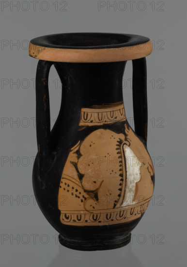 Red-figure pelike, Attic workshop; pelike (vessel), pink clay. Slightly matte black engobe. Some elements painted white. Pelike with a slender belly, wide neck widening upwards. Rolled outward rim decorated with a frieze of ox-eyes. Two bipartite handles attached vertically below the rim, extending to the gently sloping shoulders. On either side of the body, two scenes bounded top and bottom by an ox-eyes frieze. Kerch style. Scene A: Woman's head turned right, wearing a Phrygian cap whose edge is marked with a black line with elongated points; face and neck painted white. In the background on the right, a horse protoma; on the left, the front part of a griffin. Scene B: Two male figures facing each other, wrapped in long cloaks; facial features unmarked. Preservation: partially reconstructed rim. Date: 2nd half of the 4th century BC. Origin: Attica. Dimensions: height 29.9 cm, width 13.1 cm.