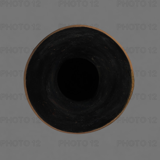 Red-figure pelike, Attic workshop, pelike (vessel), antique vessel, pink clay. Slightly matte black engobe. Some elements painted white. Pelike with a slender belly. Wide neck, widening upwards. The rim is rolled outward and decorated with a frieze (ox-eyes). Two bipartite handles are attached vertically below the rim, extending to the gently sloping shoulders. On either side of the body, two scenes are bounded at the top and bottom by a frieze of the ox-eyes type. Kerch style. Scene A: A woman's head turned to the right, wearing a Phrygian cap; the cap edge is marked with a black line with elongated points. The face and neck are painted white. In the background on the right, a horse protoma is visible, and on the left, the front part of a griffin. Scene B: Two male figures facing each other, wrapped in long cloaks; facial features unmarked. Preservation status: partially reconstructed rim. 2nd half of the 4th century BC, Attica. Vessel: pelike. Height 29.9 cm, width 13.1 cm.
