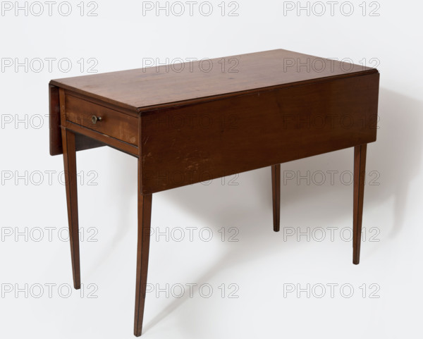 Table, flaps, neoclassicism (style), mahogany. Rectangular table with flaps on the long sides and a drawer on one short side, supported by four slender, angular, tapering legs. Edges of the legs and the lower edge of the frame have ebony veining. Flaps on steel hinges, supported when raised by rotating supports mounted on wooden hinges. Early 19th century, England. Piece of furniture; H 67.6 cm, W 92.8 cm, D 91 cm.