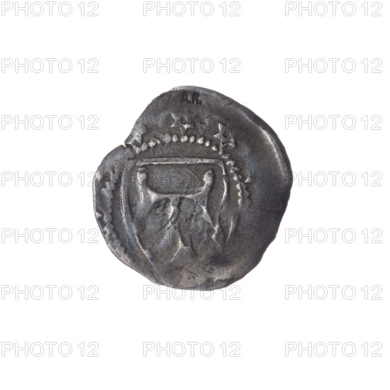 kwartnik, Boleslaw III the Extravagant (duke of Brzeg-Legnica; 1291–1352). AR punch. Obverse: shield with the letter T; in the rim between the pearl borders six-pointed stars. Reverse: a hand in a gesture of blessing separating the pearl border, on the sides a six-pointed star and the letter A in the rosette border. Iconography: hands, stars, letters, six-pointed star, shields, hand in a gesture of blessing, letter A, shield with the letter T. Rarity: R5. Date: 1311–1348. Place: Silesia, Duchy of Brzeg-Legnica-Wolów. Coin. Diameter 19.5 mm / 17.7 mm. Weight 1.56 g. Axis 310°.