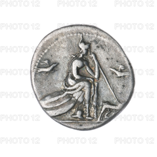 denarius; obverse: head of Roma in a Corinthian helmet facing right, below inscription ROMA, behind her the sign of value X; beaded border. Reverse: Roma in a Corinthian helmet seated facing right on a stack of shields, left hand holding a spear, helmet at her feet, in front a she-wolf nursing twins, birds flying on either side; beaded border. Punches; Corinthian helmets; helmets, shields, spears, she-wolves, twins, birds. Maker: Protassowicki, Rafal (1894–1957). Date: 115–114 BC, Roman Republic. Rome. Coin; diameter 19.5 mm; weight 3.83 g; axis 270°.