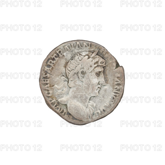Denarius, Hadrian (76–138; Roman emperor 117–138). Obverse: Bust of Hadrian with laurel wreath facing right; rim inscription: IMPCAESARTRAIAN. Reverse: Roma seated left on a chair, wearing a long robe and helmet; in her outstretched right hand she holds a figure of Victoria, in her left hand a vertical spear; behind her a shield; rim inscription: PM TR P COS III. Probably suberate, 119–122, Rome, Roman Empire (27 BC–476). Coin; diameter 16.0–18.0 mm; weight 2.95 g.
