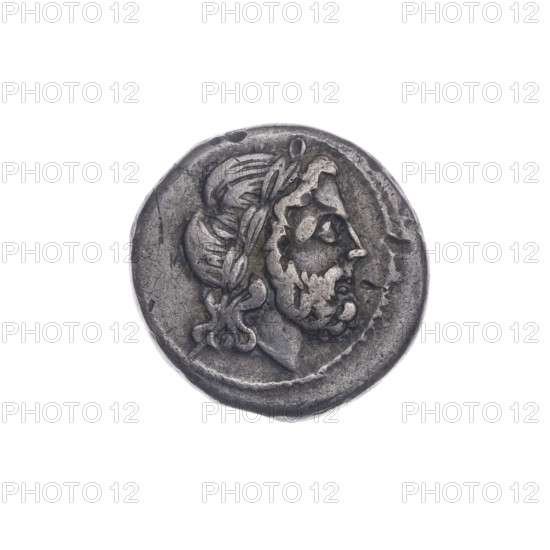 Victoria; Jupiter (mythology), head of Jupiter; Victoria (personification); Sabat, Bronislaw (1871–1953); trophies; spearheads; laurel wreath (attribute); crowning Victoria. Obverse: Head of Jupiter in a laurel wreath at right. Beaded border. Reverse: Victoria facing right, crowning a trophy; between Victoria and the trophy, a spearhead; under the line, inscription ROMA. Continuous border. Date: 211–210 BC. Period: Roman Republic (505–27 BC). Region: Apulia. Mint: (unspecified). Object: coin. Diameter: 17.0 mm. Weight: 2.64 g. Axis: 315°.