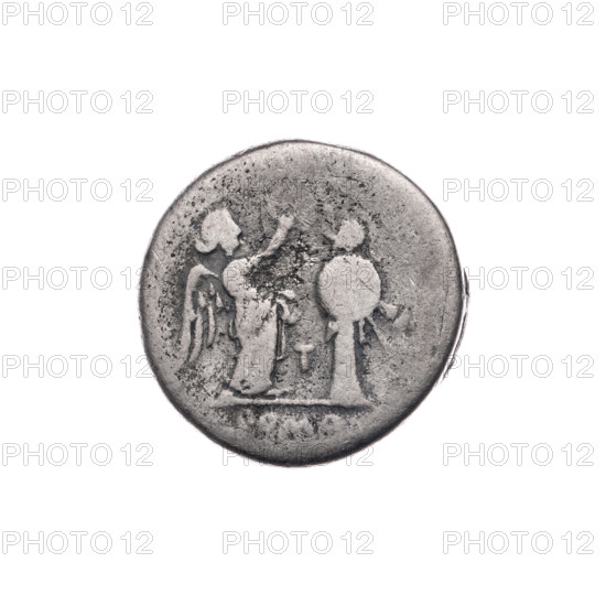 Victoria; Jupiter (mythology); Victoria (personification); head of Jupiter; laurel wreath (attribute); T (mark of issue); crowning Victoria; L (mark of issue). Obverse: head of Jupiter in a laurel wreath at right; below, the letter L. Pearl border. Reverse: Victoria facing right, crowning a trophy; between Victoria and the trophy, the letter T; under the line, the inscription ROMA. Continuous border. 211–210 BC, Roman Republic (505–27 BC); Luceria. Coin; diameter 16.5 mm; weight 3.03 g; axis 315°.