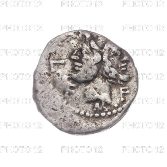 Denarius, M. Furius Philus (publisher), 119 BC. Obverse: Head of Janus in a laurel wreath; around the inscription MF, LF. Beaded border. Reverse: Roma wearing a Corinthian helmet, holding a scepter in her left hand and crowning a trophy with her right; above a star; on both sides of the trophy a carnyx and a shield; below the line the inscription PHILI (PHI in ligature). Pearl border. Roman Republic (505–27 BC), Rome. Coin. Diameter 18.6 mm; weight 3.76 g; axis 270°.