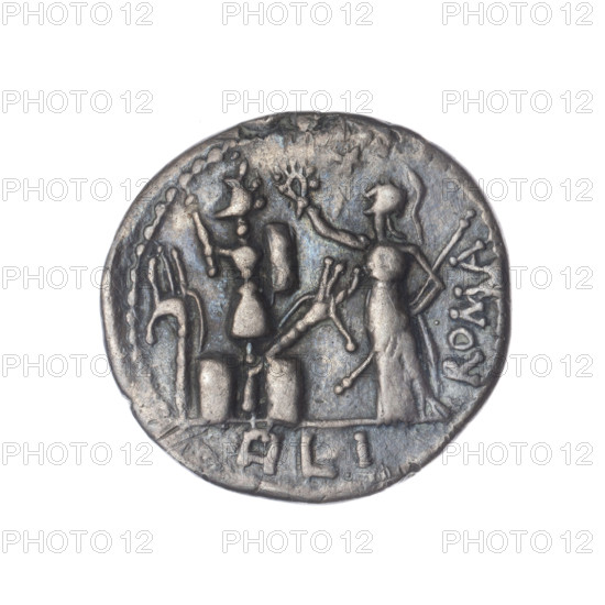 Denarius; issuer: M. Furius Philus (fl. 119 BC). Obverse: Head of Janus in a laurel wreath; inscription M·FOVRI·L; beaded border. Reverse: Roma, in a Corinthian helmet with a sceptre in her left hand, crowning a trophy with her right; above a star; behind the trophy the inscription ROMA; on both sides of the trophy a carnyx and a shield; under the line the inscription PHILI (PHI in ligature); pearl border. Date: 119 BC; Culture: Roman Republic. Material: silver coin; diameter 19.4 mm; weight 3.38 g; axis 135°.