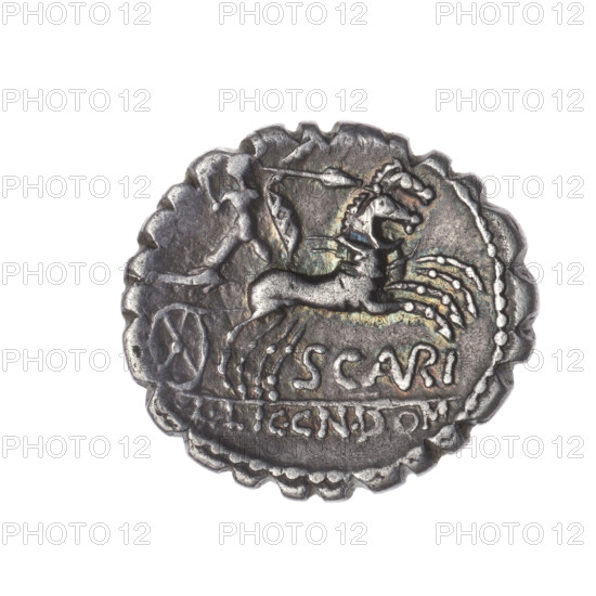 denarius serratus, Aurelius Scaurus, M. (fl. 118 BC), publisher, Licinius Crassus, L. (fl. 118 BC), publisher, Domitius Ahenobarbus, Cn. (fl. 118-96 BC), publisher, Roma (mythology), warrior on a biga, shields, helmets, carnyx, spears, bigas, Attic helmets, warriors, head of Roma. Obv. Head of Roma in an Attic helmet to right; in front the inscription M.AVRELI (VR in ligature); behind the inscription ROMA and the value sign X (crossed out). Beaded border. Rev. Naked warrior on a biga to right, holding reins, shield and carnyx in left hand, a spear in right; below the inscription SCAVRI (AVR in ligature); below the line the inscription L.LIC.CN.DOM. Pearl border. 118 BC, Roman Republic (505–27 BC), Narbonne, coin; diameter 20.3 mm, weight 3.78 g, axis 0°.