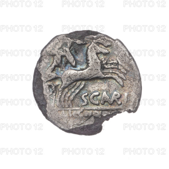 Denarius subaeratus; Aurelius Scaurus, M. (fl. 118 BC), publisher; Licinius Crassus, L. (fl. 118 BC), publisher; Domitius Ahenobarbus, Cn. (fl. 118–96 BC), publisher. Obv: Head of Roma in an Attic helmet facing right; in front the inscription, behind ROMA and the value sign X (crossed out). Beaded border. Rev: Naked warrior on a biga facing right, holding reins, shield and carnyx in left hand and a spear in the right; below the inscription SCAVRI (AVR in ligature); below the line the inscription LIC.CN.DO. Pearl border. 118 BC, Roman Republic (505–27 BC). Coin (plated), diameter 18.5 mm, weight 2.59 g, axis 180°.