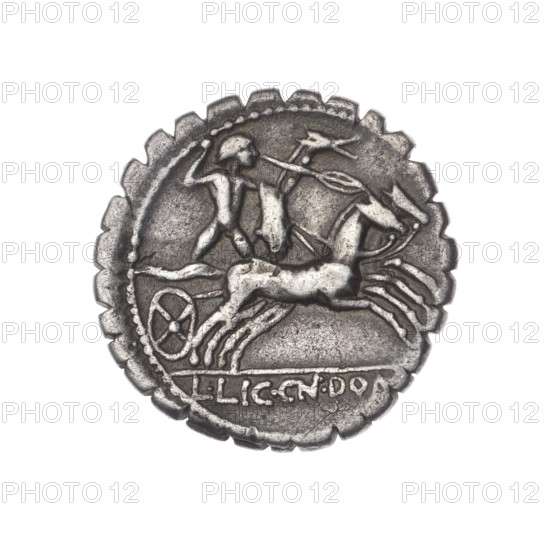 Denarius serratus; obverse: head of Roma in an Attic helmet facing right, inscription L.COSCO.MF (S lying) beside it, sign of value X, beaded border. Reverse: naked warrior on a biga facing right, holding reins and shield, carnyx in left hand and spear in right; under the line inscription L.LIC.CN.DOM., beaded border. Makers/publishers: L. Cosconius, L. Licinius Crassus, Cn. Domitius Ahenobarbus (fl. 118–96/118 BC); attributed artist Semerau-Siemianowski, Wladyslaw (1849–1938). Roman Republic, 118 BC. Coin (denarius serratus), diameter 19.4 mm, weight 3.76 g, axis 180°, Narbonne.
