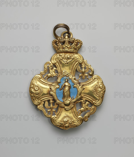 The Grand Cross of the Order of the Polish Canonesses of Warsaw, an equal-armed cross with a grand baroque artistic form, the arms of which form the axes of a four-field coat of arms of the Republic of Poland. The spaces between the arms of the cross, enclosed by arabesque connectors, form fields in which the openwork coats of arms of the Crown and Lithuania, the Eagle, and the Tail are alternately placed heraldically. In the center, at the intersection of the arms, on the obverse side, is a plaque in the form of a shield with the Korczak coat of arms, the background of which is in amaranth enamel. This plaque is movable, hinged on the right side, and has two small holes, at the top and bottom, for pegs to hold it closed. The reverse of the plaque contains remnants of enamel. Under the plaque is an oval reliquary containing remains of St. Adelaide. On the reverse side, at the intersection of the arms, a plaque with the image of Our Lady of the Immaculate Conception on a blue background...