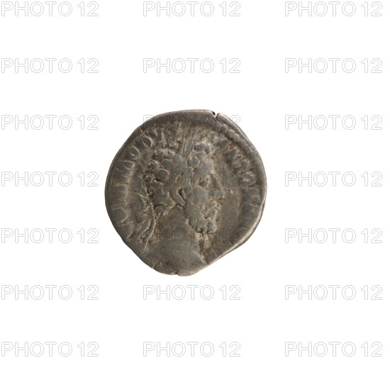 Denarius of Commodus (reign 177–192 CE). Obverse: laureate bust of Emperor Commodus right, inscription COMMODV NTON AV, pearled border. Reverse: VICTORIA standing right, writing on a shield set on a tree trunk, prisoner at her feet, inscription VIIII IMP VI COS IIII PP, pearled border. Roman, dated 183–184 CE. Silver coin (3.01 g).