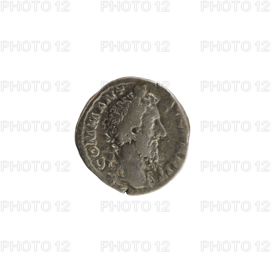 Denarius, Commodus (161–192; Roman emperor 177–192). Obverse: Emperor's head right, with laurel wreath; pearly border; inscription 'COMM ANT AVG P BRIT'. Reverse: Annona standing left, holding a statuette in her right hand and a cornucopia in her left; in front a modius, behind her a ship's prow; inscription 'PM TR P VIIII IMP VII COS IIII PP' and line 'ANN'; pearl border. Roman, 184 CE; coin; weight 2.82 g.