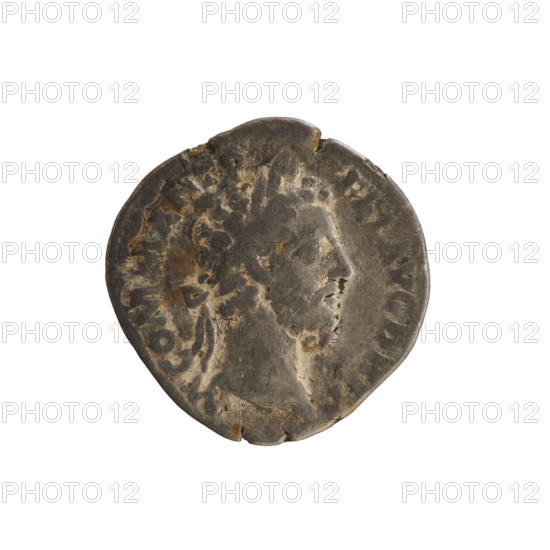 Denarius of Commodus (reigned 177–192). Obverse: laureate and draped bust of the emperor right; inscription 'M COMM ANT P FEL AVG BRIT'. Reverse: Jupiter seated left on throne, holding a branch in his right hand and scepter in his left; inscription 'IOV EX SVP PM TR P ... COS V'. Pearled border. Date: 186–187. Roman Empire. Material: coin; weight 2.87 g; axis 180°. Subjects/iconography: imperial busts, Jupiter, scepter.